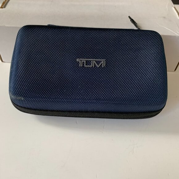 The product is a navy blue hard case amenity kit bag by TUMI for Delta Airlines.